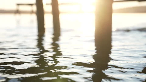 Pier reflection on rippling water at sunrise Stock Footage 310197495