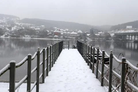 Pier on the river in the snow 库存照片