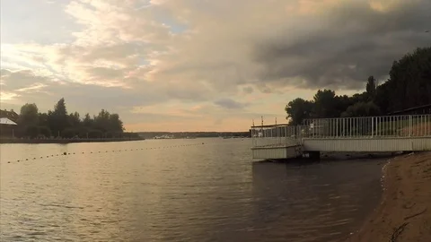 Pier on sandy shore of a pond at sunset Stock Footage 82369092