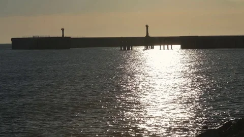 Pier with sea waves in sunset lights. Video stock 76849365