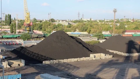 On the pier in the seaport lies a stack of coal for loading onto a ship and wago Stock Footage 118985484