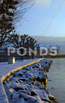 Pier with snow, lake view. Stock Photos