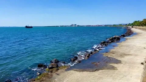 The pier with stairs to the sea. A path protected by large stones and embankment Stock Footage 252026862