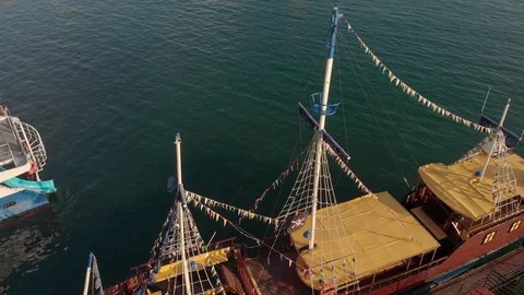 At the pier stands an old ship with masts. Aerial shot Video stock 116164037