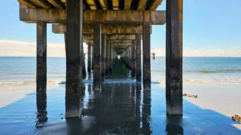 Pier Structure Overlooking the Ocean. A captivating view from beneath a pier Stock Photos