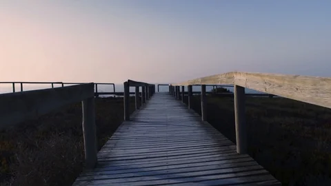 A pier at sunset, leading to the ocean Video stock 96180893