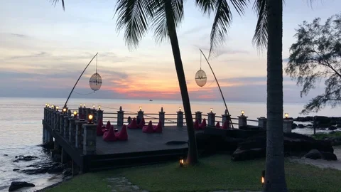 Pier surrounded by palm trees at the beach at sunset in Vietnam Stock Footage 107573736