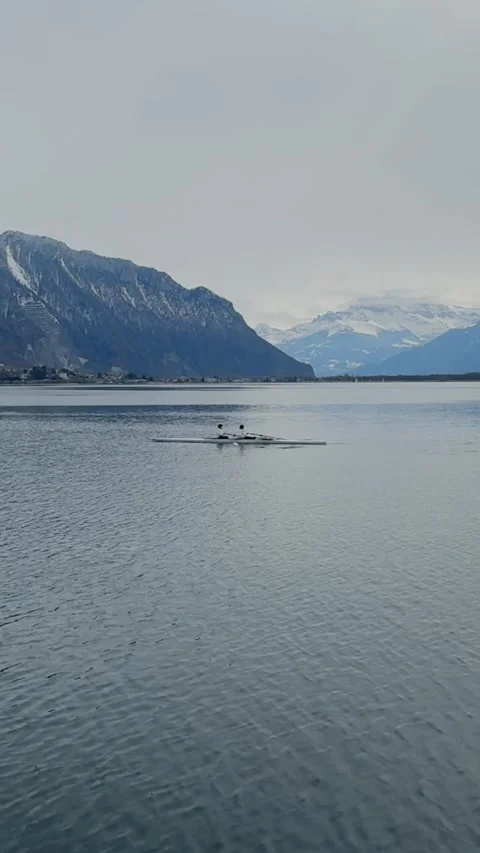 Pier view on Lake Geneva with distant rowing Montreux vertical 動画素材 331660664