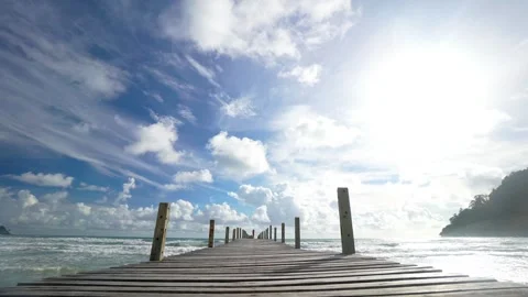 A pier with a view of the ocean and a cloudy sky Stock Footage 313554299