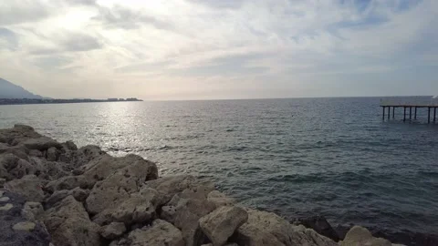 Pier view on the rocks and accompanied by gentle waves Stock Footage 219770431