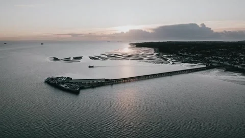 A pier is visible in the distance, with the ocean in the background Stock Footage 298255361