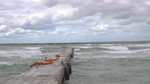 Pier with a wave on the gray background of the sea with a pier, a path to the Stock Footage 136054138