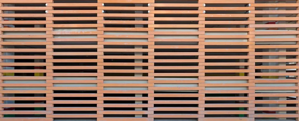 Pierced wall of elongated elements in horizontal rows as background. Fotos de archivo