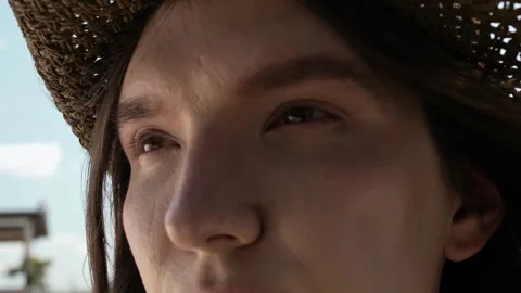 Piercing dreamy look of a young guy with long straight hair in a braided hat Stock Footage 264508699