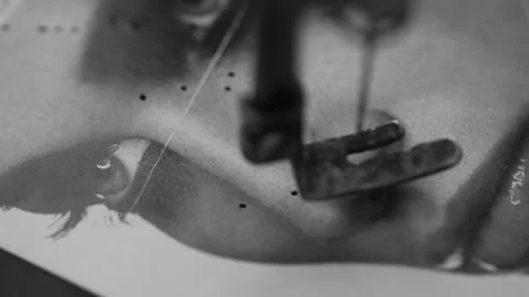 Piercing a magazine page with an old-fashioned sewing machine Stock Footage 237724404