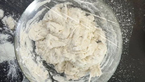 Piercing plastic wrap overhead Stock Footage 121119492