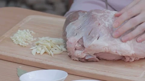 Piercing thick piece of pork with knife for marinating Stock-Footage 7766779