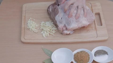 Piercing thick piece of pork with knife for marinating Stock Footage 7766780