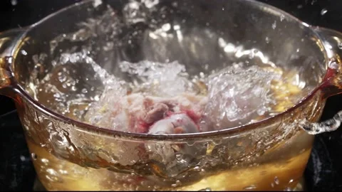 Pig Bone Falling in Boiling Water Video stock 232369419