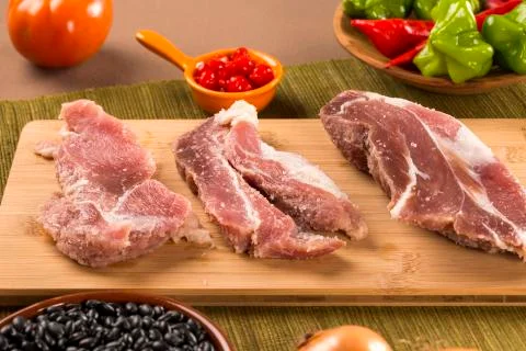 Pig loin raw in wooden background Stock Photos