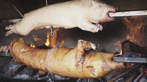 Pig is roasting on a spit Stock Footage 68002771
