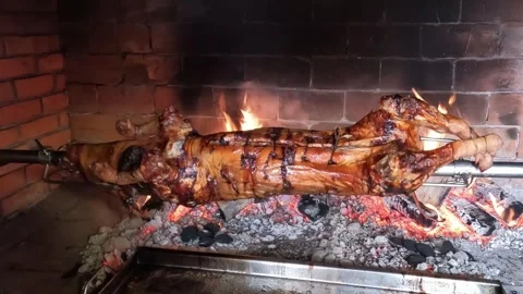 Pig spinning on a spit Stock Footage 297184878