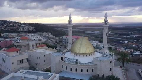 Pigeons fly over the mosque at sunset Stock Footage 170178682