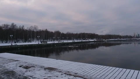 Pigeons walking along the snow-covered embankment of Lake Onega in Petrozavodsk Stock Footage 324903232