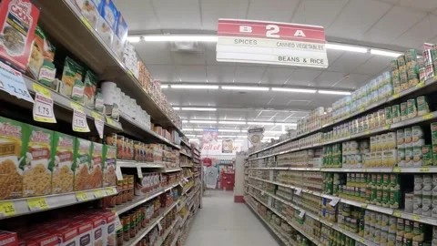Piggly Wiggly grocery store POV walking down can vegetable aisle packed out Stock Footage 250109435
