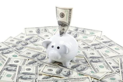 Piggy Bank on the background of a stack of dollar bills Stock Photos