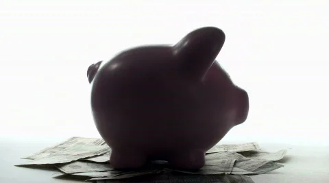 Piggy bank on cash rotating V3 - HD Stock Footage