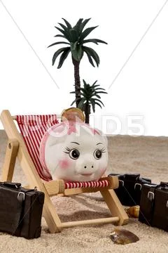 Piggy bank in a deck chair Stock Photos