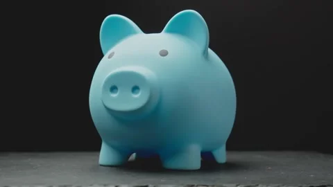 Piggy bank shown from different angles in a close-up view at black background Stock Footage 342563161
