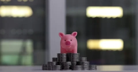 Piggy bank stands on stack of silver dollar coins Stock Footage 273842650