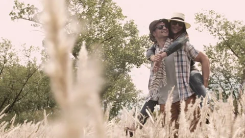 Piggyback. Casually dressed heterosexual involve couple having fun together in f Stock Footage 199631848