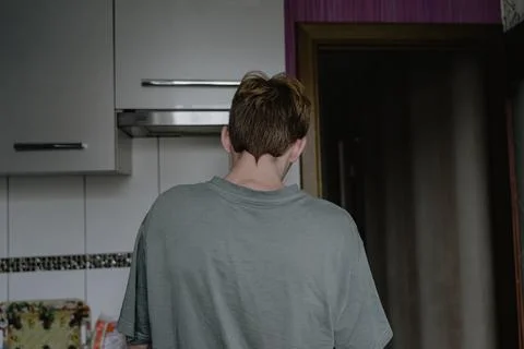 Pigtail on the back of the head, the guy is standing with his back, with a no Stock Photos