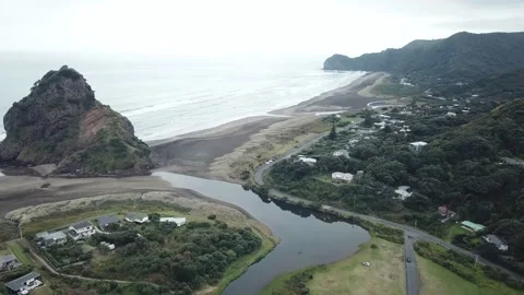 Piha Beach- Ariel push in over river to North Piha Beach Stock Footage 208874240