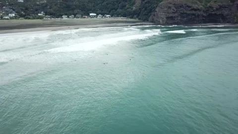 Piha Beach- Mini Orbit shot of south piha surfers Stock Footage 208869345