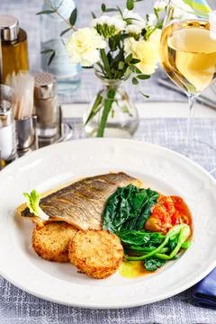 Pike perch fillet with vegetable cutlets and vegetables in the restaurant set Stock Photos