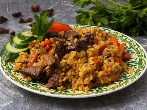 Pilaf with beef on a gray background. Close up Stock Photos
