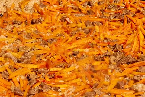 Pilaf cooked in a large cauldron as a background Stock Photos