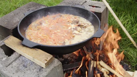The pilaf is cooked over a fire Stock Footage 304097143
