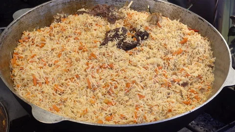 Pilaf in a large cauldron in 4K. Stock Footage 124768046