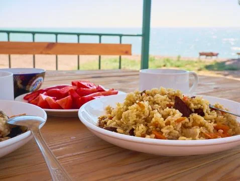 Pilaf is on the table with vegetables Stock Photos
