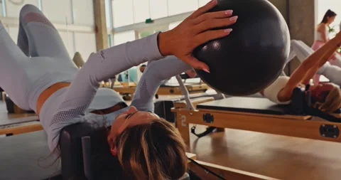 Pilates Class with Exercise Balls in Modern Studio Stock Footage 323946541