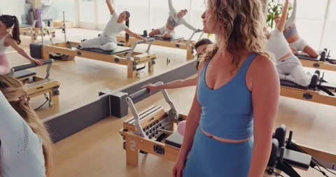 Pilates Class in Modern Studio with Professional Instructor Stock Footage 323930445
