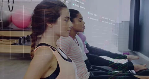Pilates class reacting to instructor cue, lifting hips into reverse plank with Stock Footage 328648996