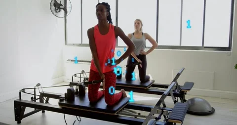 Pilates client pulling cable rotating torso under binary overlay engaging core Stock Footage 317791919