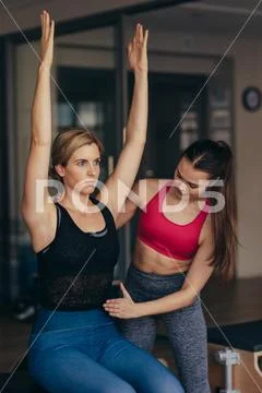Pilates instructor training woman at the gym Stock Photos