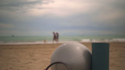 Pilates Setup on Beach with Exercise Ball and Yoga Mat Stock Footage 275459193